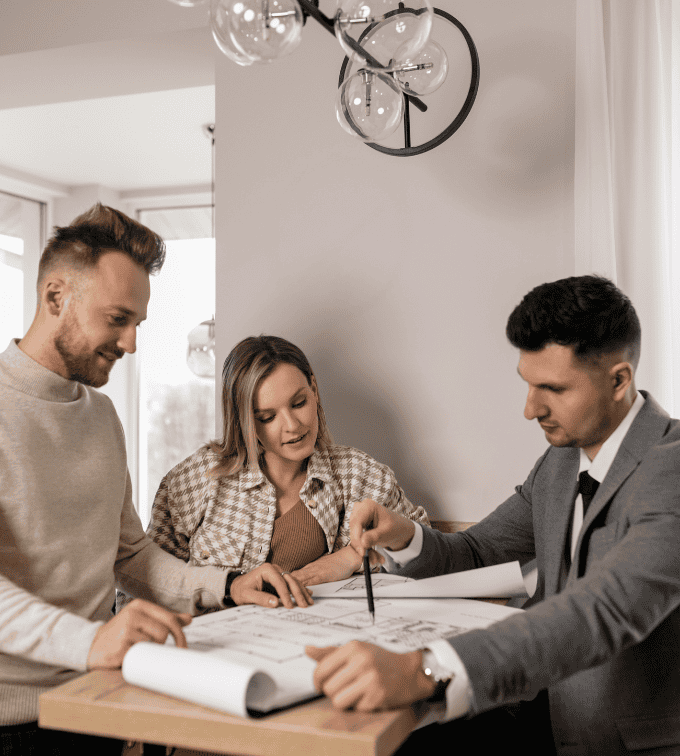 Real estate agent reviewing property plans with a couple during a home buying consultation - Cloud Based Real Estate Brokerage